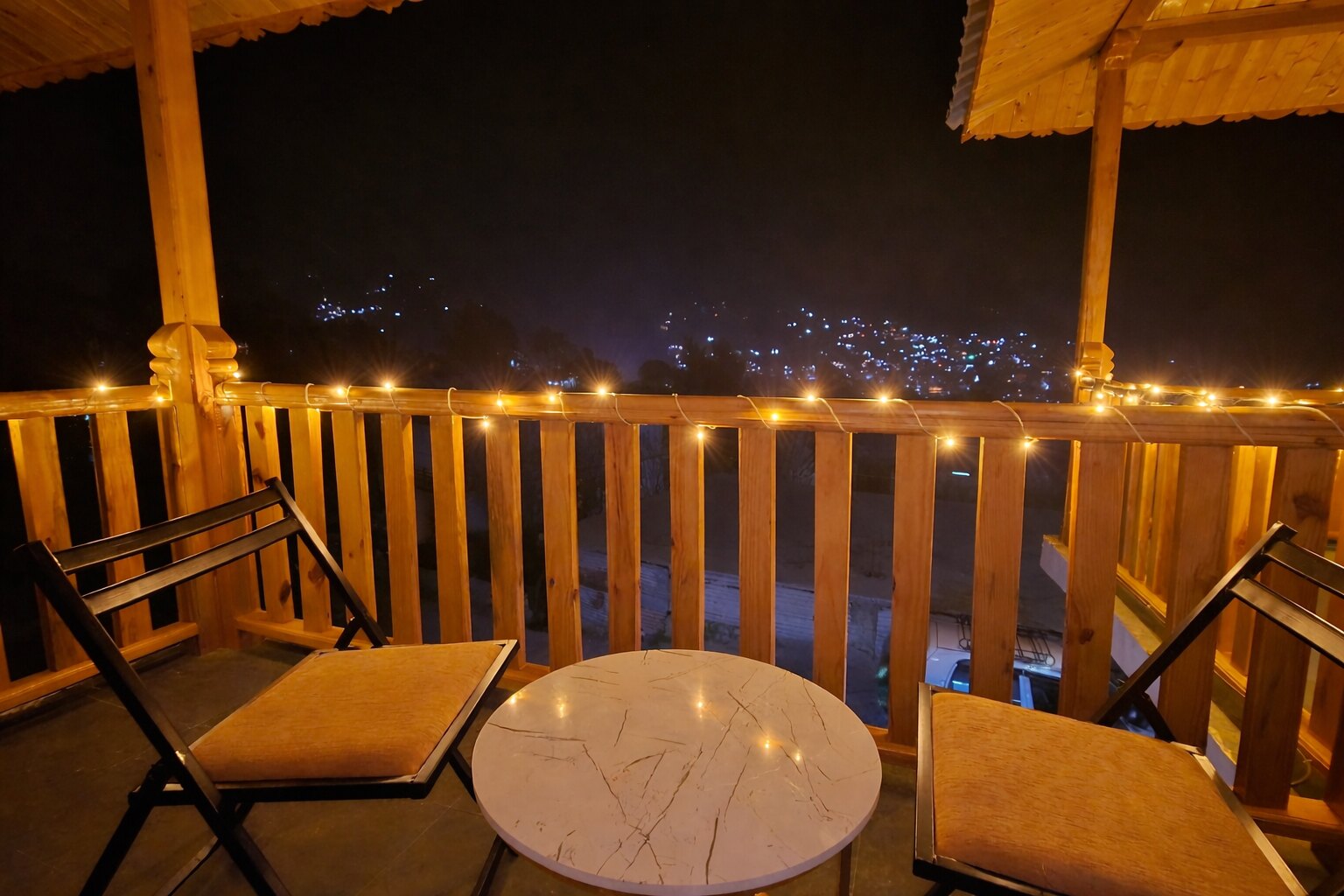 Private Forest Nook Manali balcony overlooking the valley at night