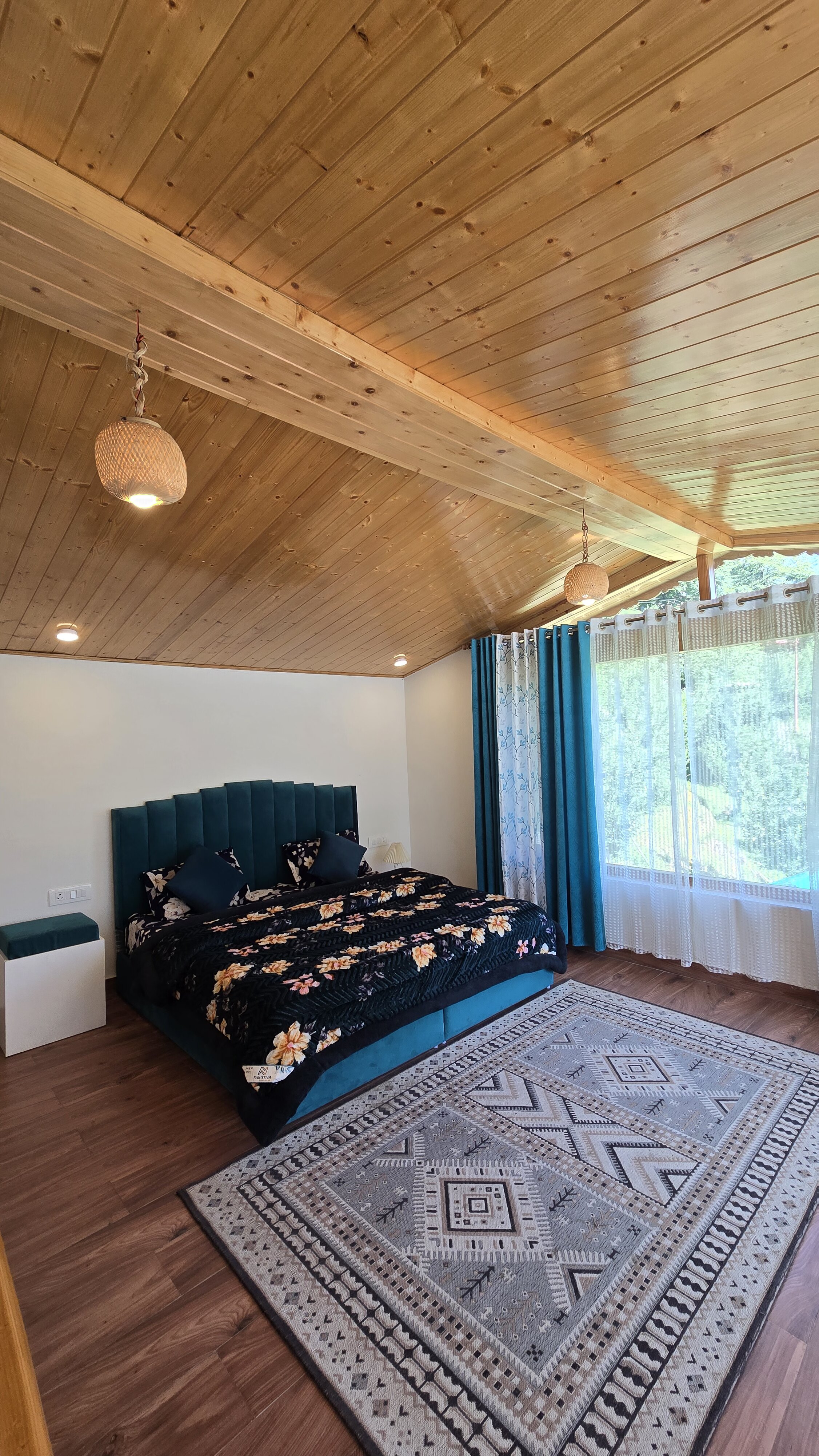 Wood-panelled bedroom at Forest Nook Manali